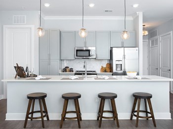 Kitchen island with bar stool seating Kitchen island with bar stool seating at St Mary's Square North Apartments, Raleigh, North Carolina - Photo Gallery 6