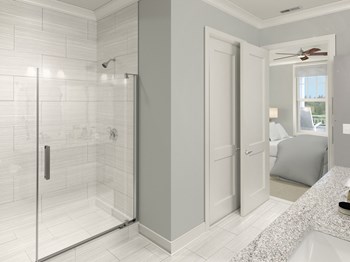 Bathroom with glass shower doors at St Mary's Square North Apartments, Raleigh, NC, 27605 - Photo Gallery 22