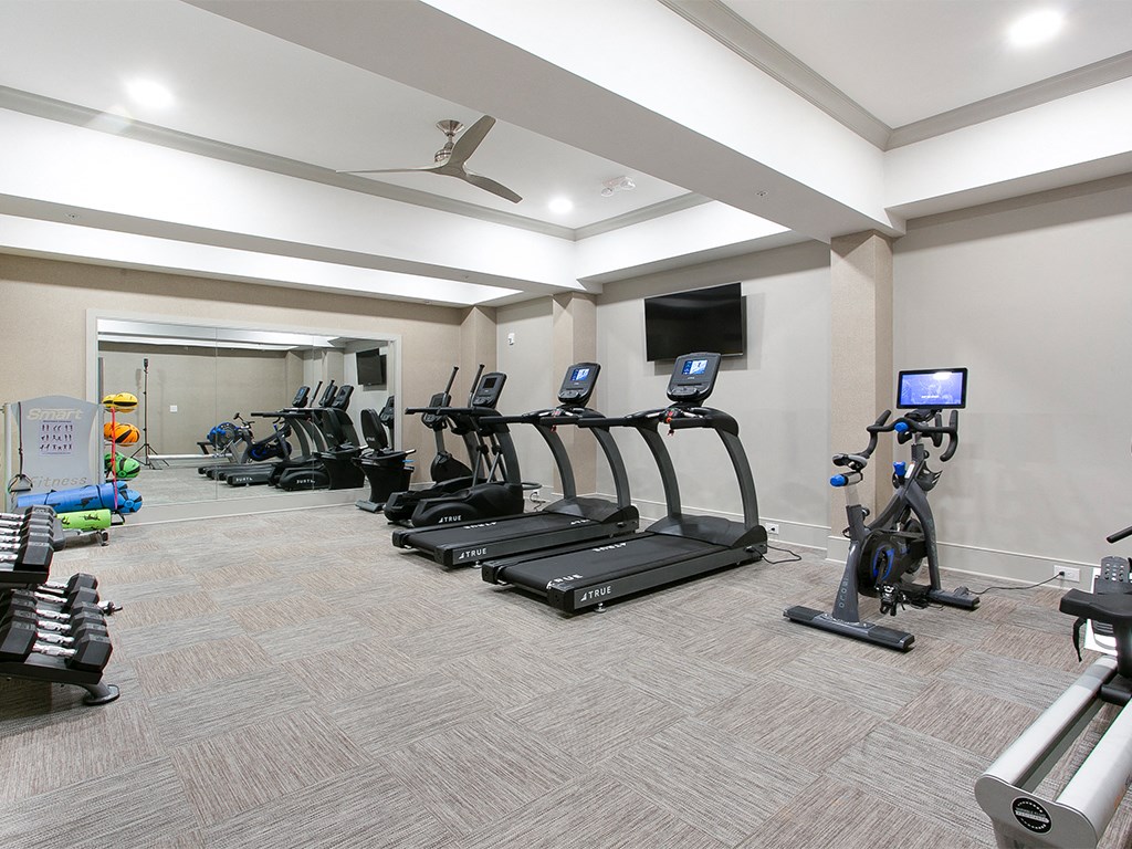 Fitness center with cardio equipment at St Mary's Square North Apartments, Raleigh, NC