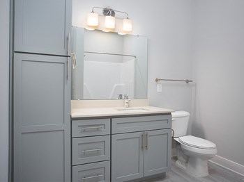 Guest bathroom with vanity and storage at St Mary's Square North Apartments, Raleigh, 27605 - Photo Gallery 23