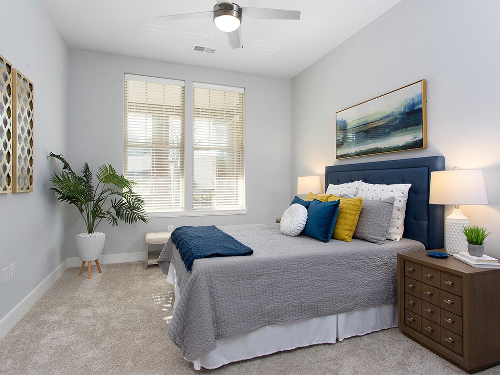 Primary bedroom with bed and side tables at St Mary's Square North Apartments, Raleigh, North Carolina