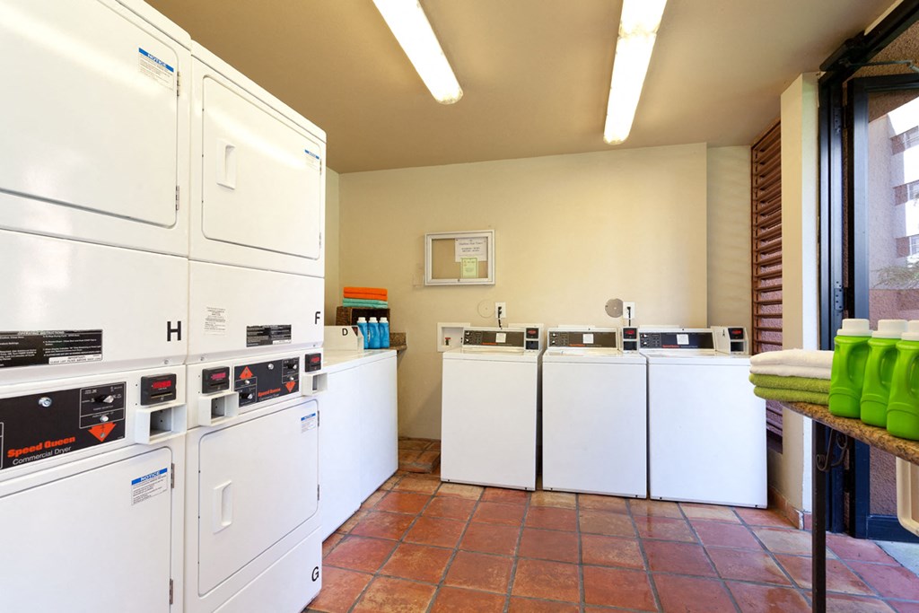 a laundry room with several washes and dryers in it