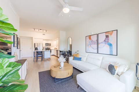 A living room with a white couch and a coffee table.
