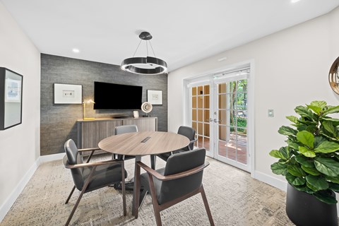 A modern dining room with a round table and chairs.