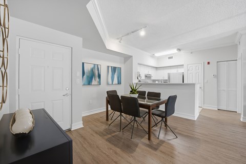 A dining room with a table and chairs.