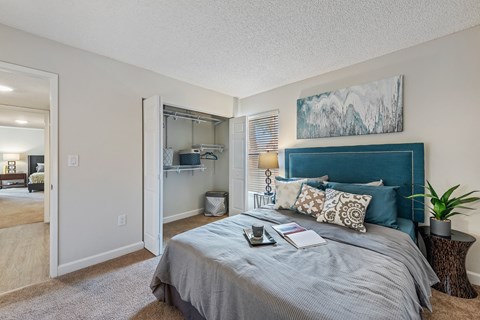 our apartments offer a bedroom with a large bed and a closet