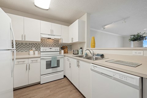 the preserve at ballantyne commons apartment kitchen with white cabinets and appliances