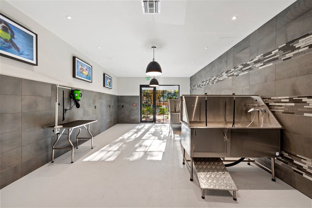 a large kitchen with a large stainless steel refrigerator and a grill