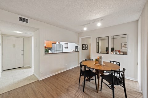 a dining room with a table and chairs and a kitchen