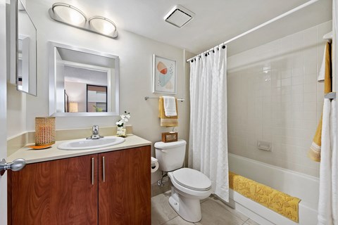 a bathroom with a toilet and a sink and a shower
