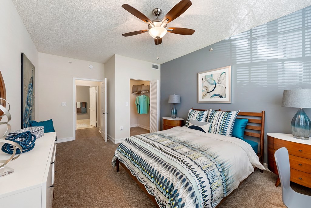 a bedroom with a bed and a ceiling fan