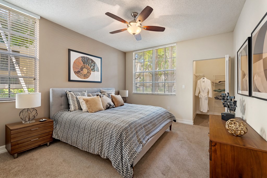 a bedroom with a bed and a ceiling fan