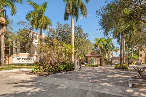 a street with palm trees in front of a building