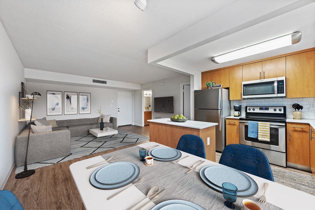 a kitchen and living room with a table and chairs