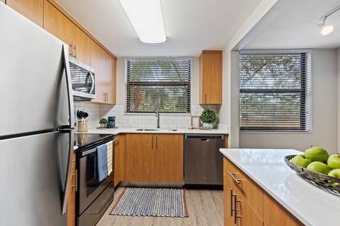 a kitchen with stainless steel appliances and wooden cabinets
