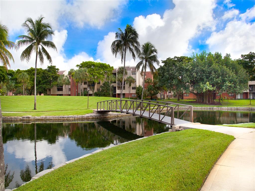 a bridge over a body of water with palm trees