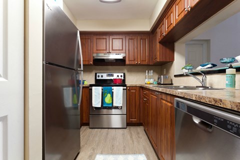 a kitchen with stainless steel appliances and wooden cabinets