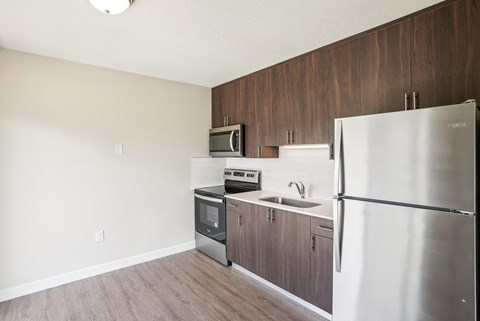 a kitchen with stainless steel appliances and a refrigerator