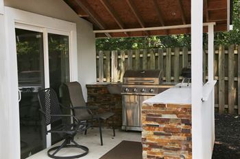 a covered patio with an outdoor kitchen
