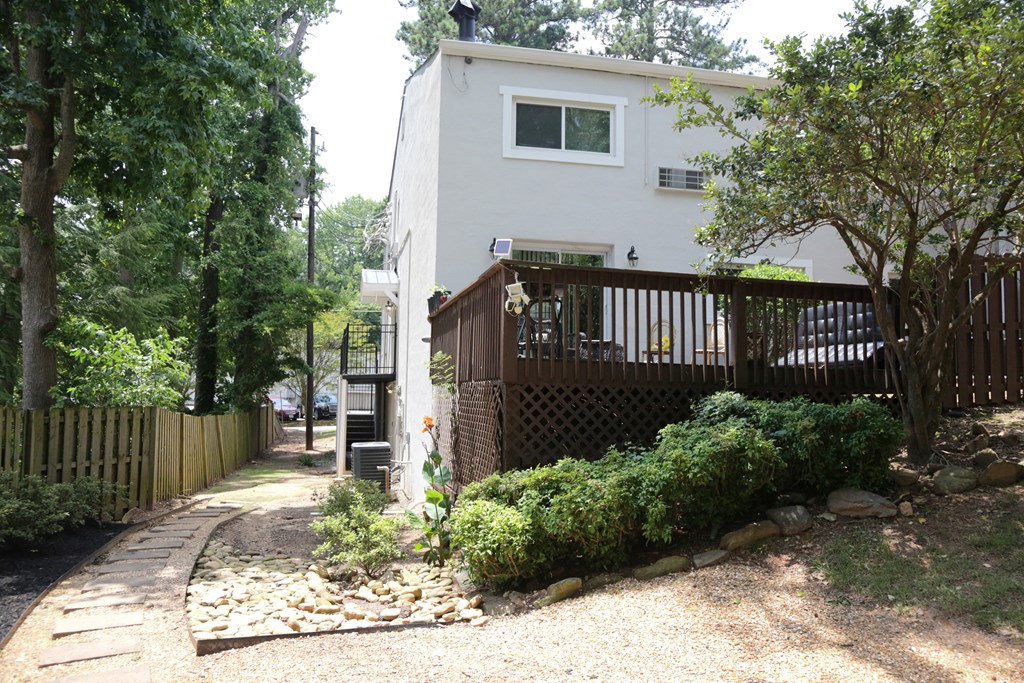 a fenced patio behind the apartment building