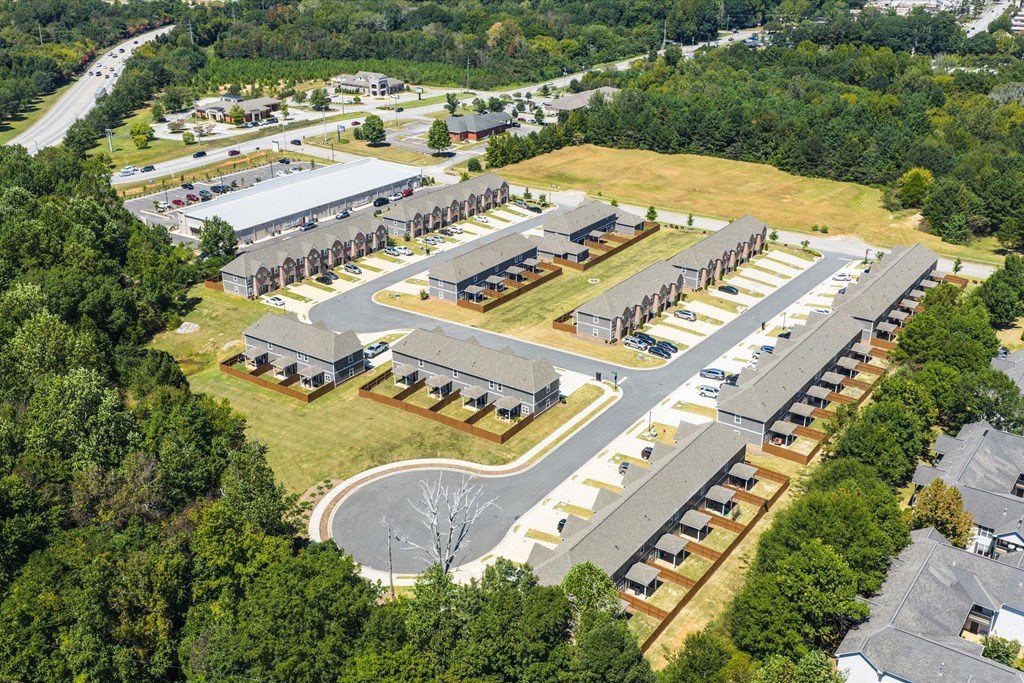 An aerial view of a large building complex surrounded by trees.