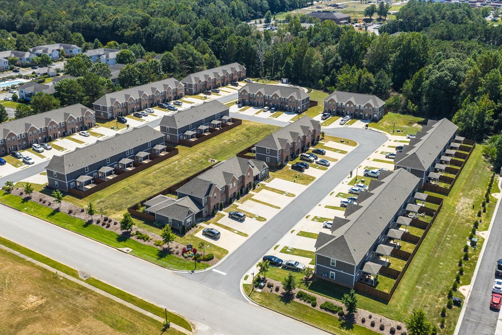 A bird's eye view of a residential area with houses and cars.