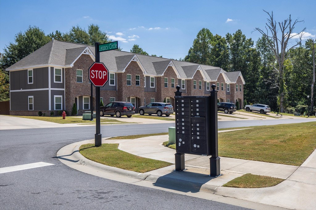 A stop sign is in front of a brick building.