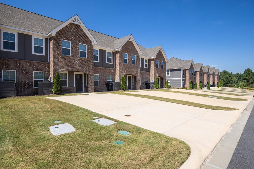 A row of houses with a clear blue sky above them.