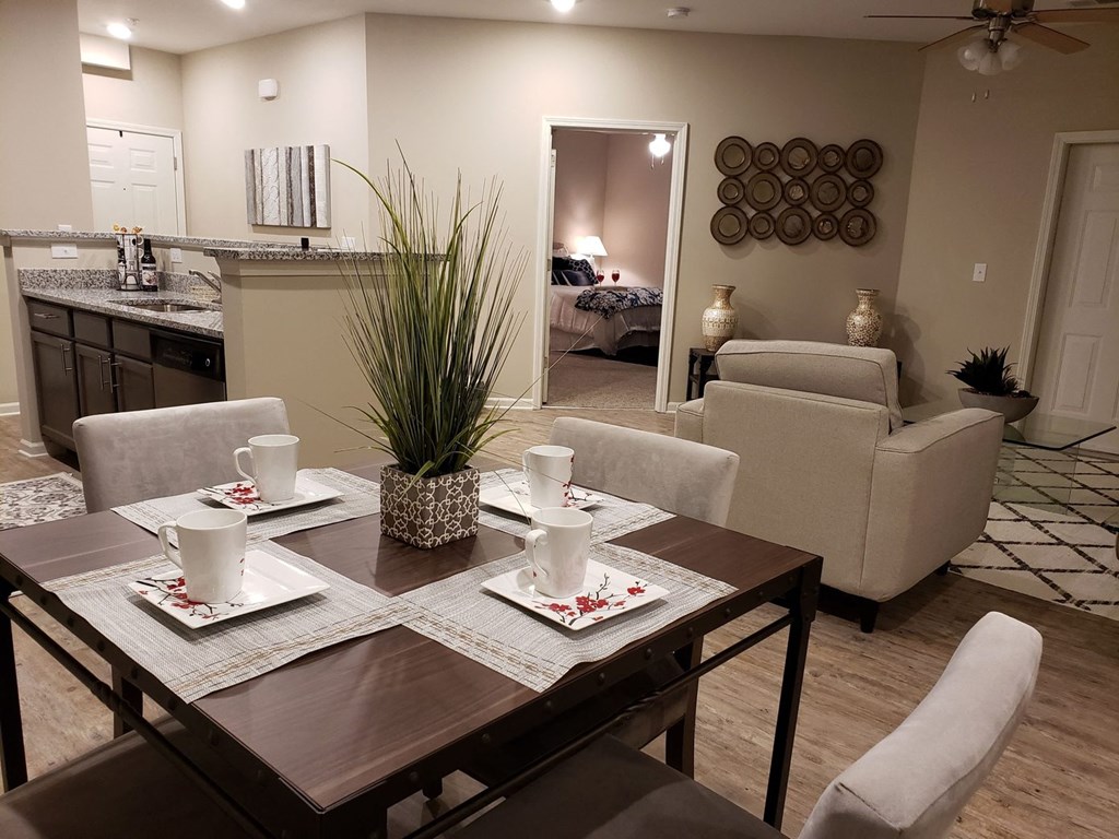 a dining room and living room with a table and chairs