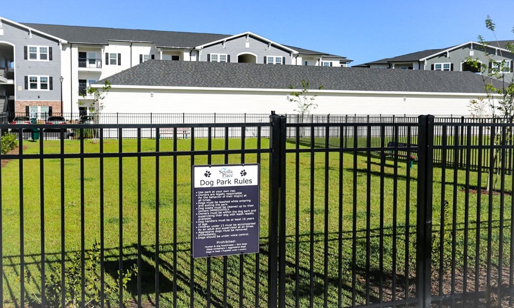 a fence with a sign on it in front of a house