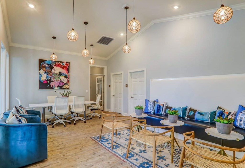 a living room with blue furniture and a table with chairs