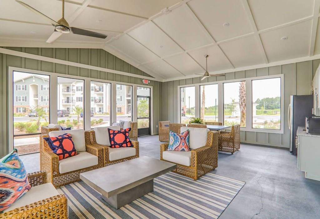 a covered porch with couches and a table