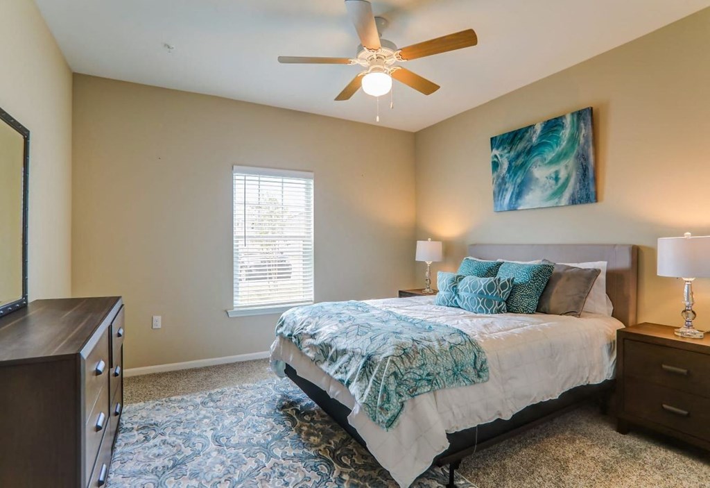 a bedroom with a bed and a ceiling fan