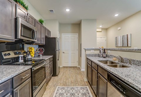 a kitchen with stainless steel appliances and granite counter tops