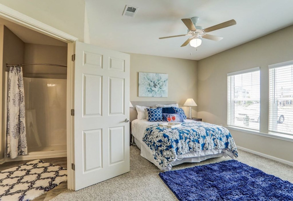 a bedroom with a bed and a ceiling fan