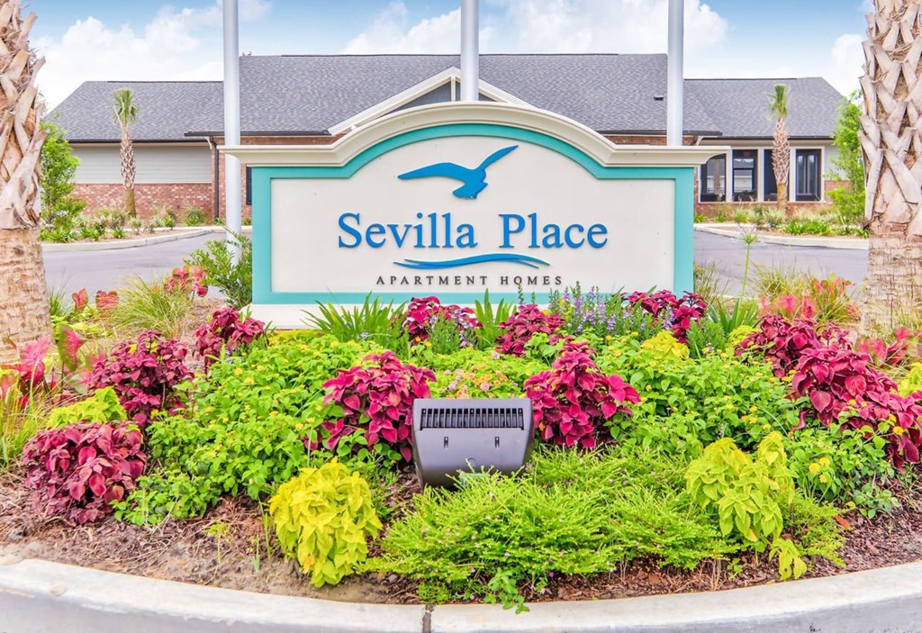 the entrance place apartments entrance sign with flowers