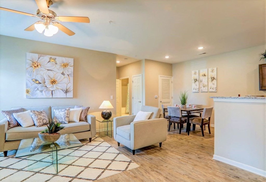 a living room with furniture and a ceiling fan