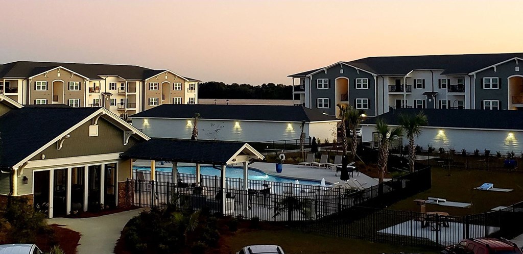 an aerial view of a swimming pool with houses around it