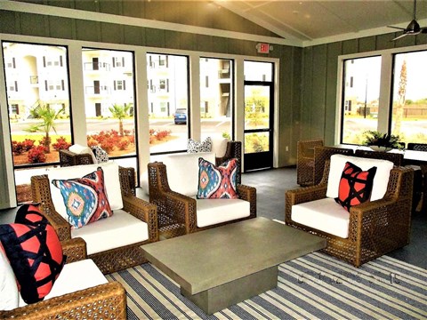 a living room with wicker chairs and a coffee table