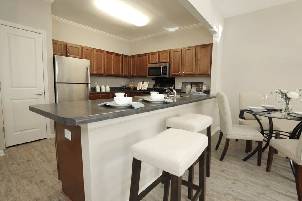a kitchen and dining area with a counter and stools