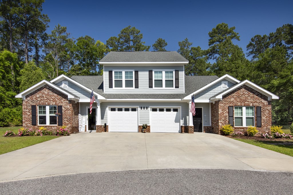 a house with a white garage door in front of a driveway