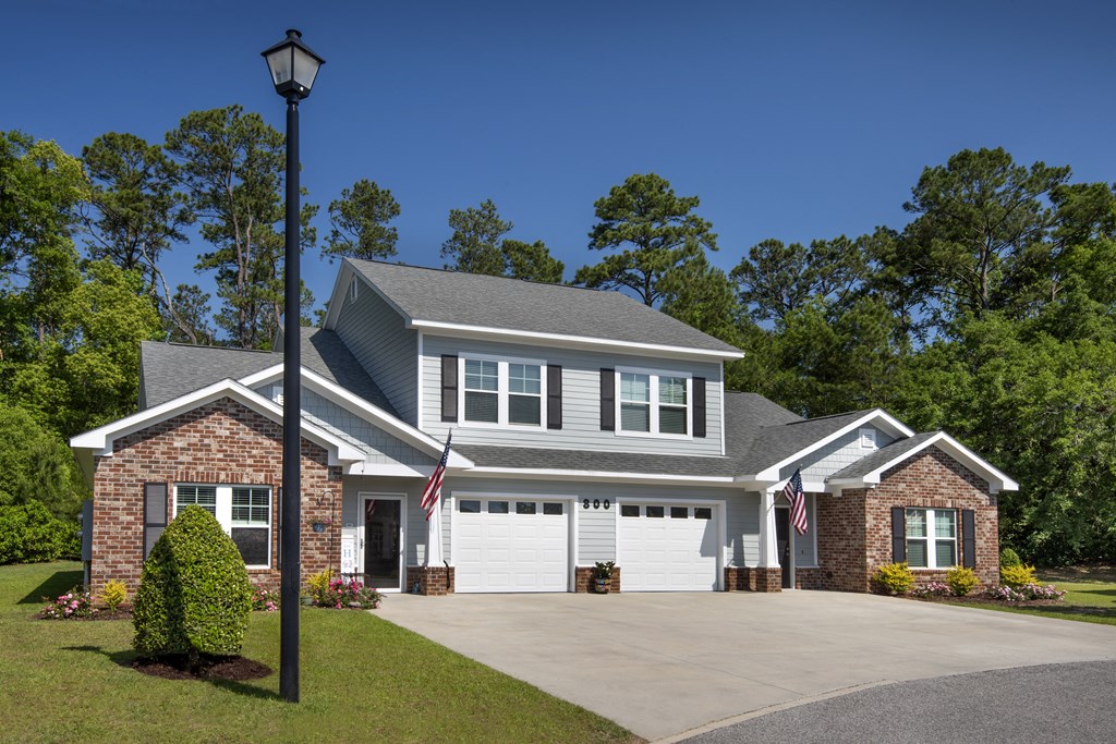 a house with a driveway and a street light in front of it