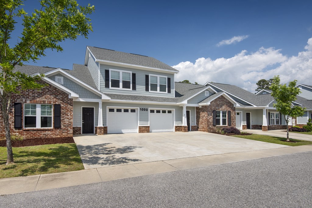 a white house with a garage and a driveway