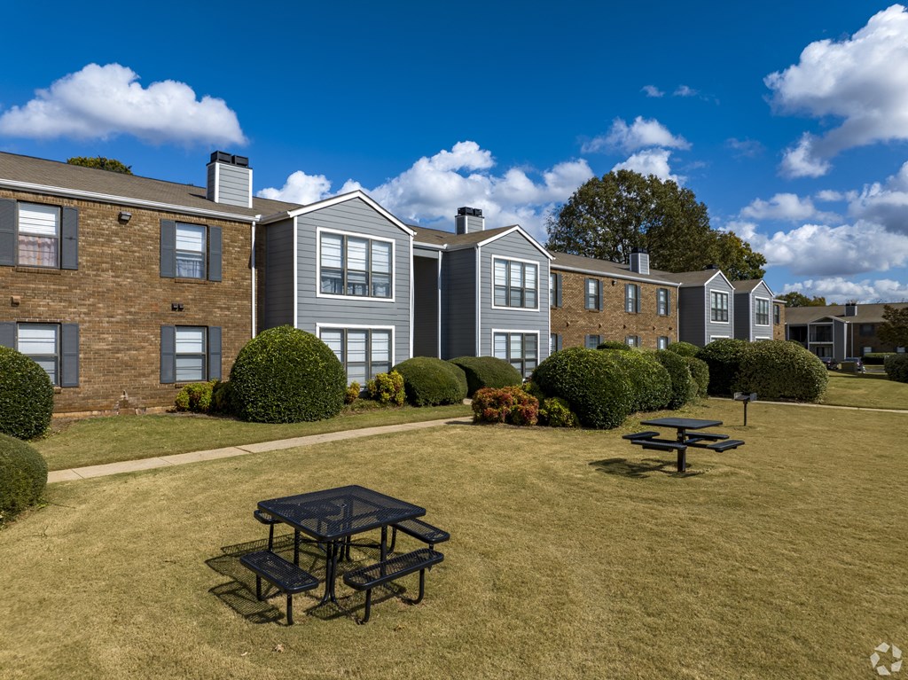 A sunny day at a residential area with a picnic table in the foreground.