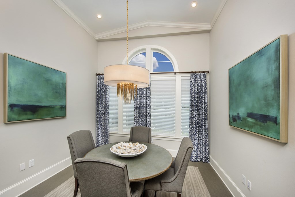 a dining room with a table and chairs and a window