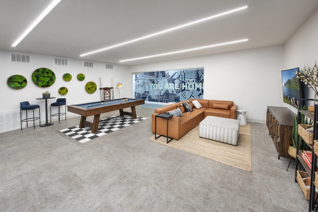 A room with a pool table and a couch.