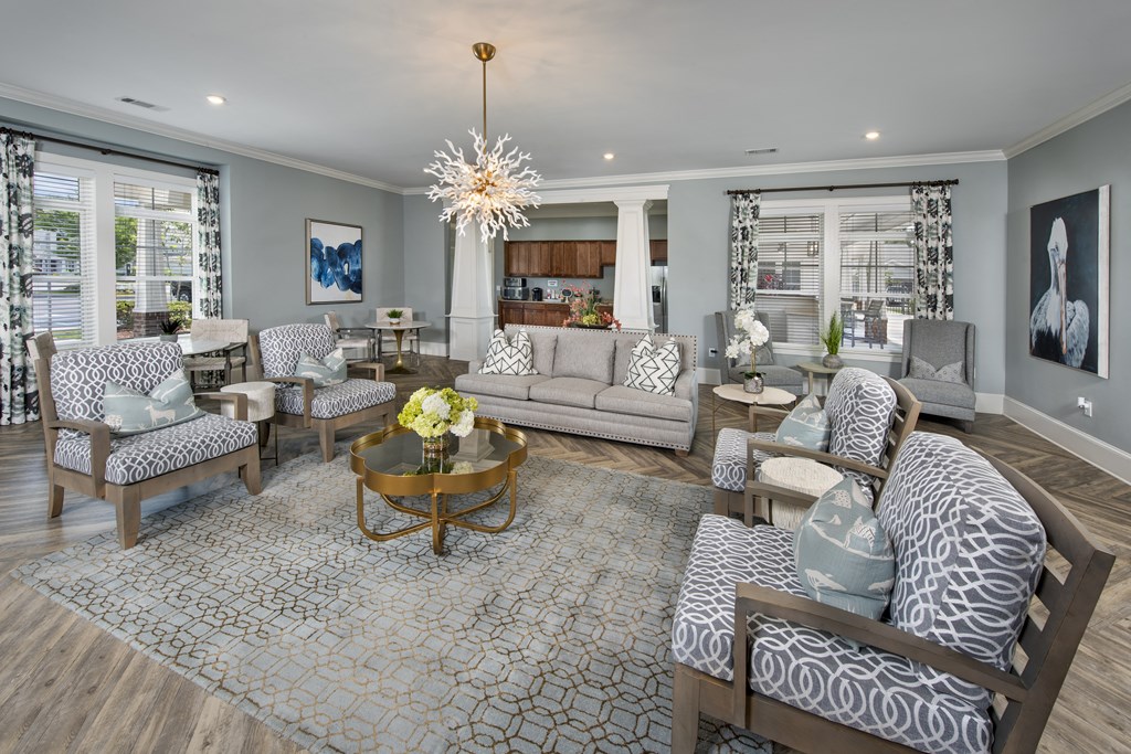 a living room with blue and white furniture and a chandelier
