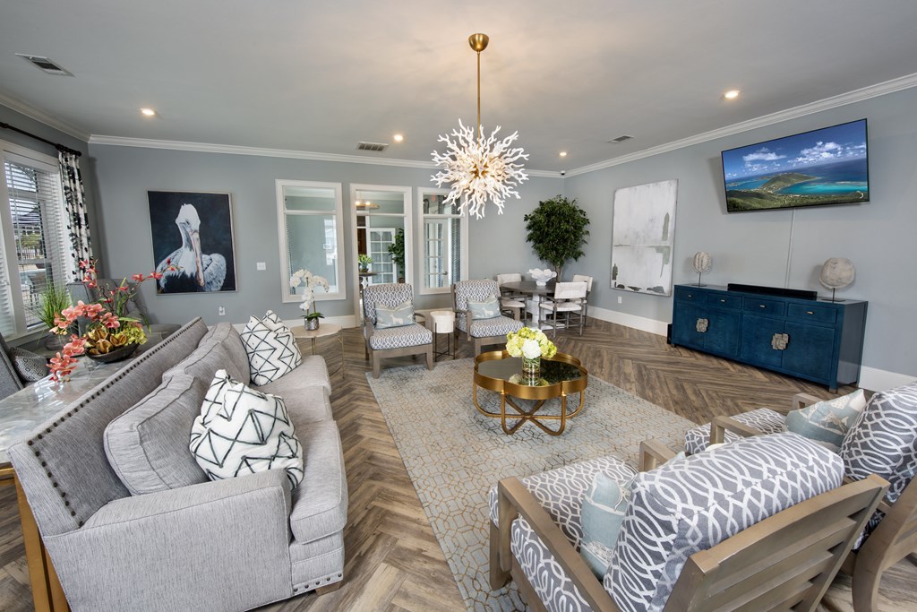 a living room with couches and chairs and a tv