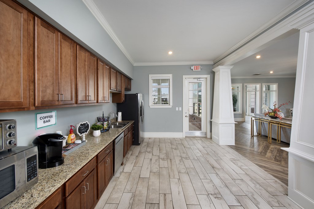a kitchen and living room with wood floors and wood cabinets