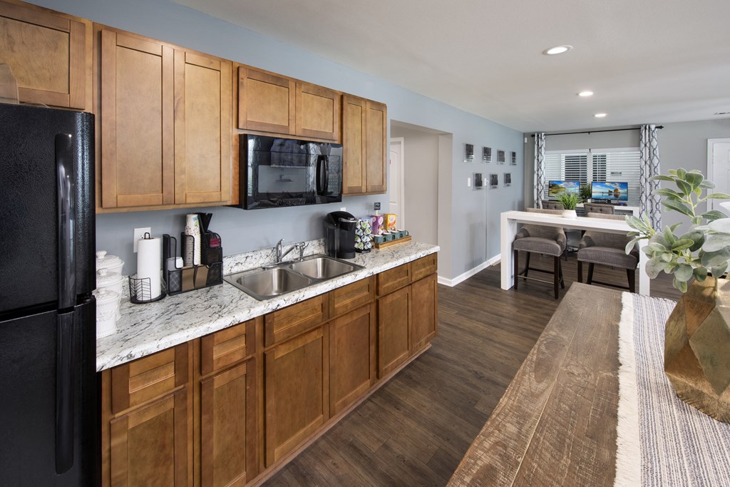 a kitchen with wooden cabinets and a sink and a refrigerator